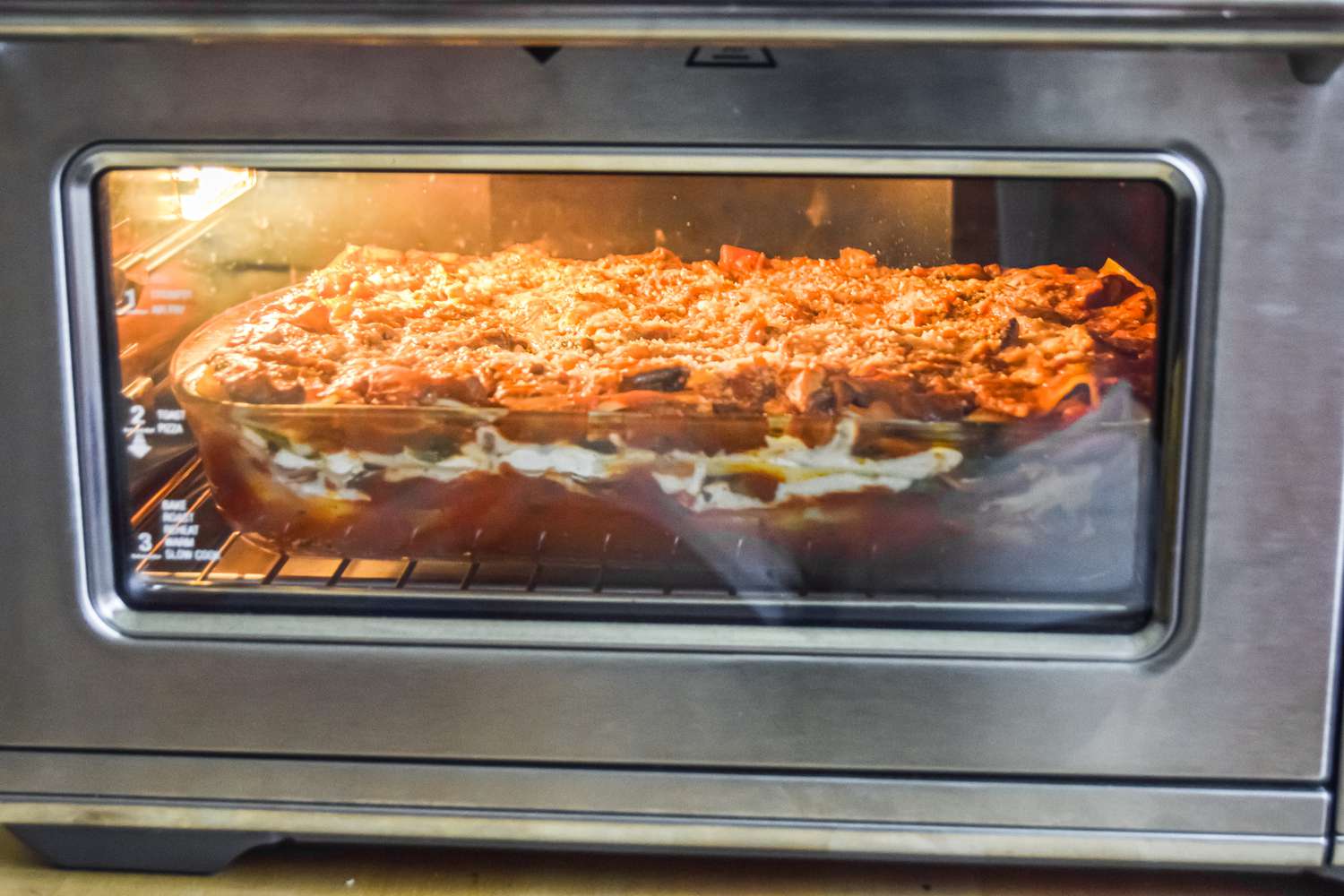 Vegetarian Spinach and Mushroom Lasagna in the Oven with foil taken off