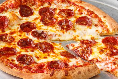 Pepperoni pizza with one slice partially removed