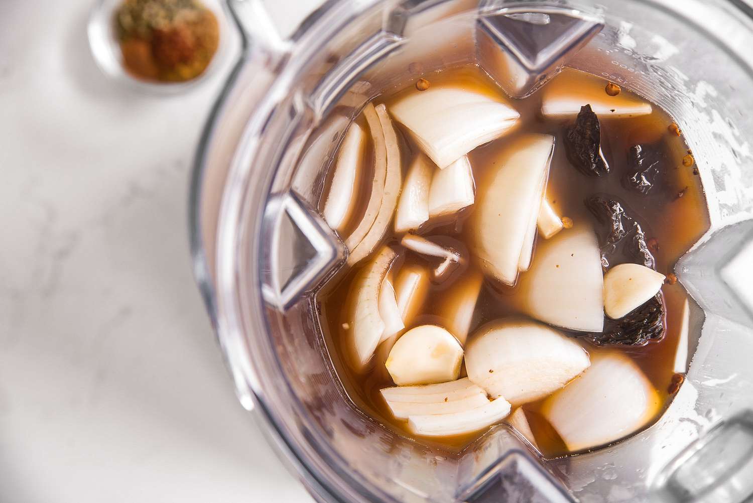 Onions, Ancho Peppers, and Stock Soaking in a Blender for Red Enchilada Sauce Recipe