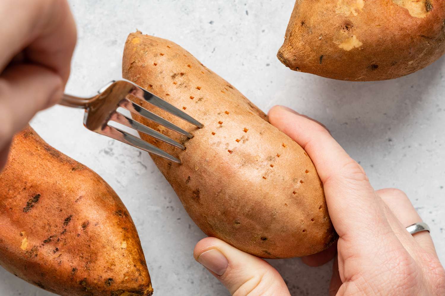 Prick sweet potatoes with fork