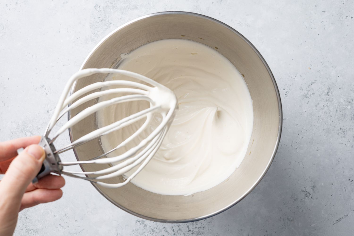 Whipped Cream with Soft Peaks on a Whisk Attachment and Mixer Bowl