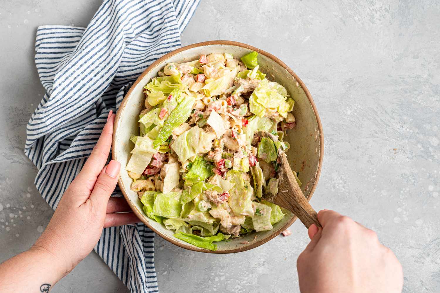 Ingredients mixed in a bowl to make a tuna pasta salad recipe.