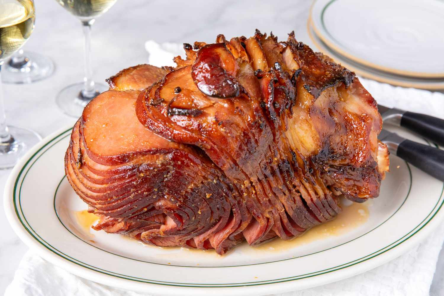 A glazed spiralcut ham presented on a serving platter