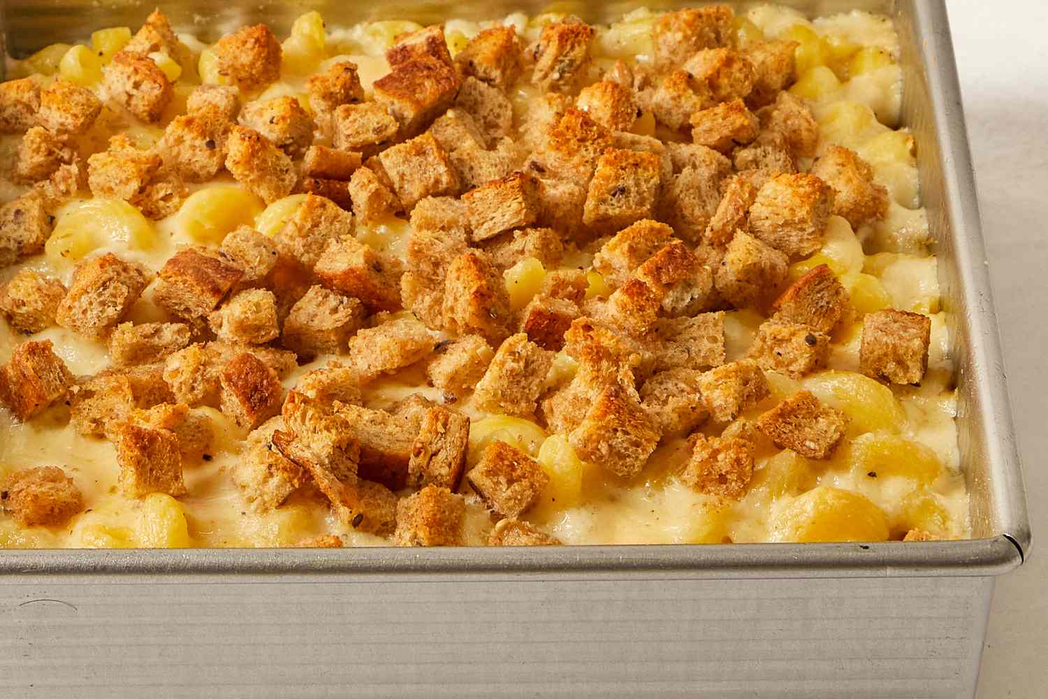 Baked pasta with cheese and breadcrumbs in a rectangular pan