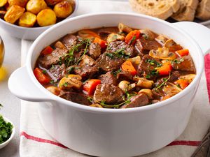 Beef stew in a white Dutch oven