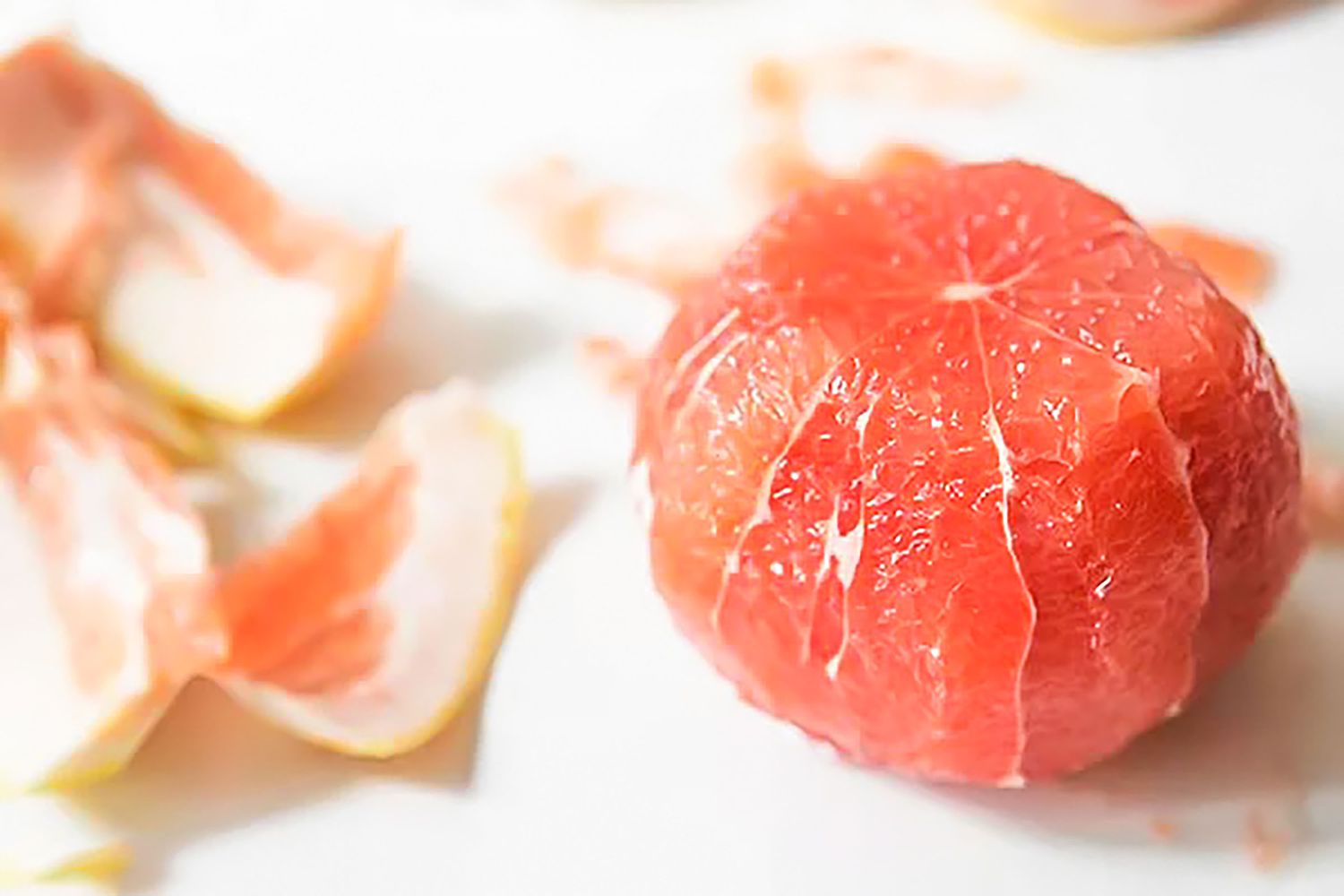 Peeled Grapefruit and Next to It, the Rinds