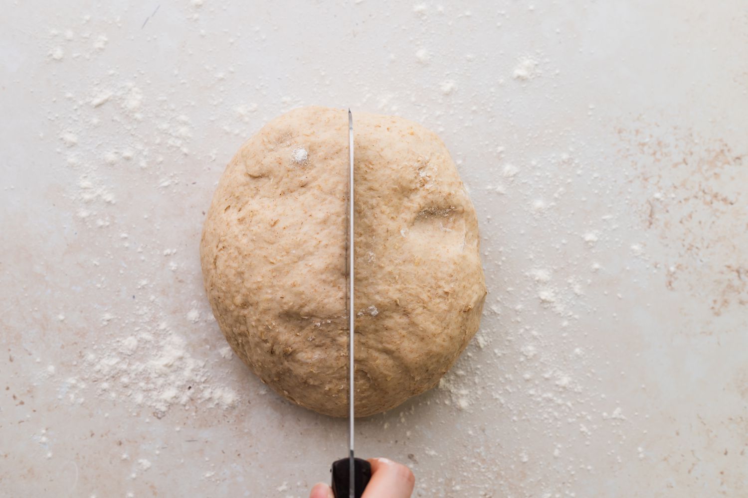 Shaping homemade oat bread.