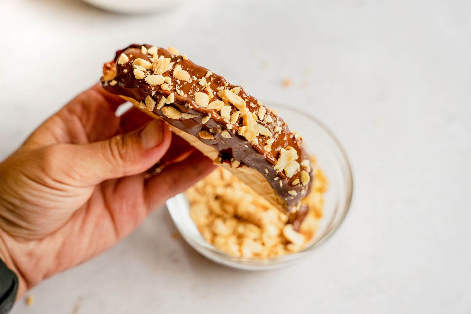 Sprinkle chopped peanuts on top of the melted chocolate.