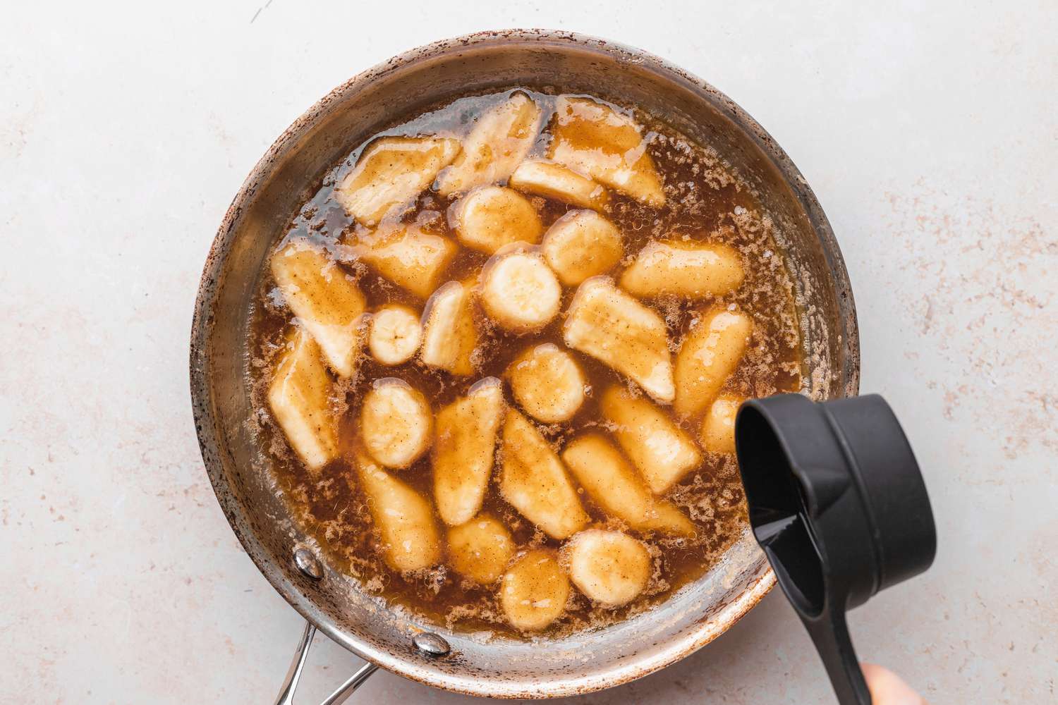 Rum Added to Bananas Foster in Skillet