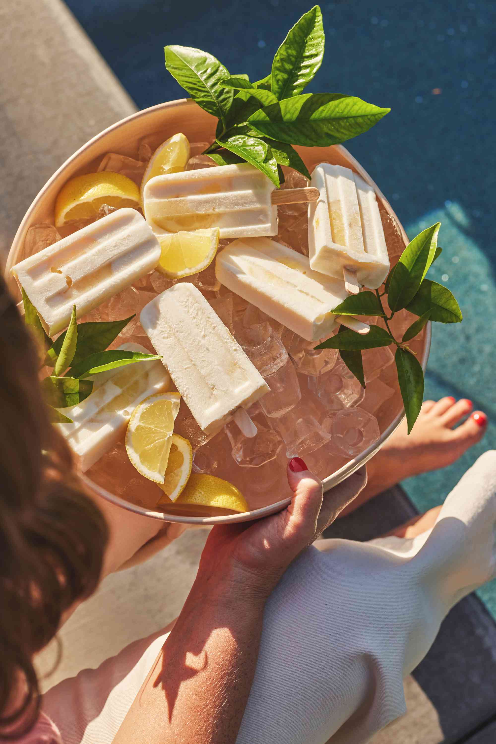 Gaby's Limoncello Yogurt Popsicles on ice by pool