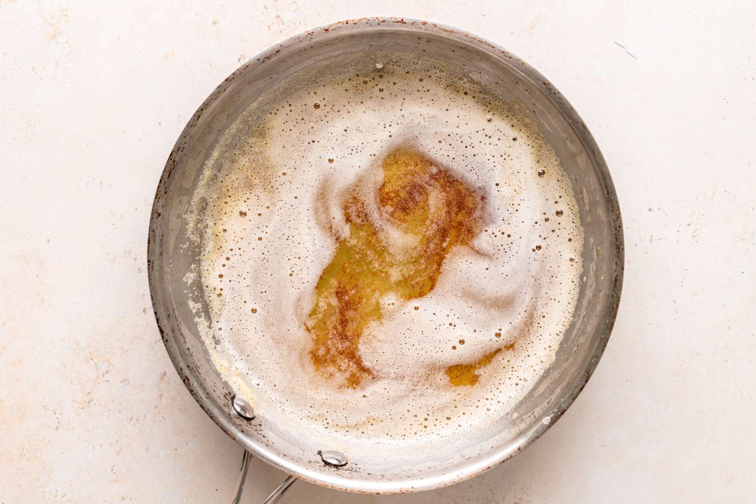 A pot of melted butter that is starting to brown.