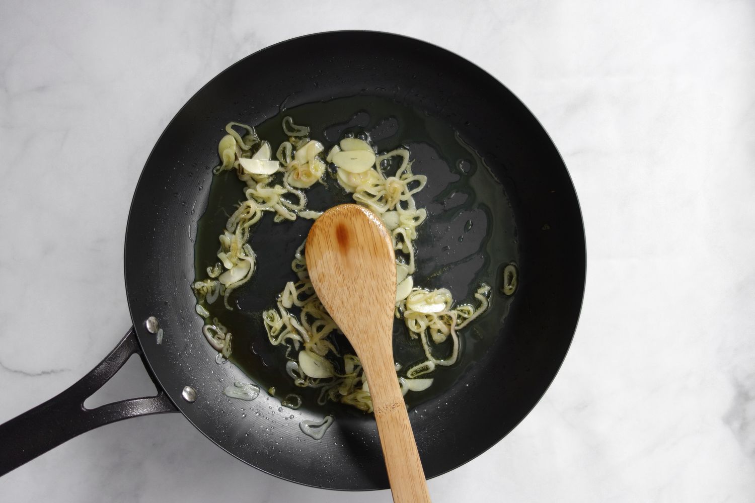Garlic and Shallots Pan Fried in Skillet for Linguine with Spicy Creamed Corn 