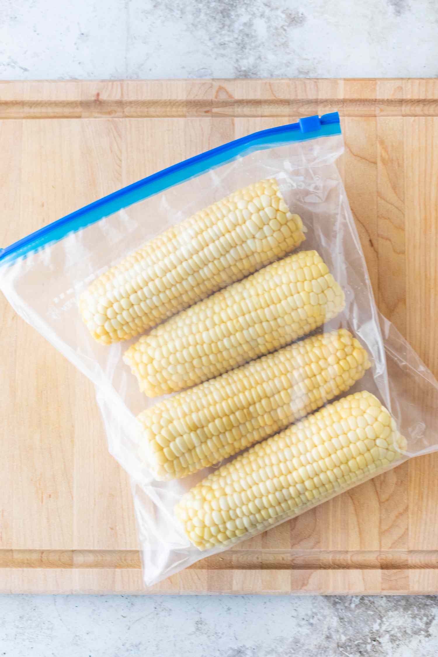 Four whole corn cobs in a ziptop plastic bag