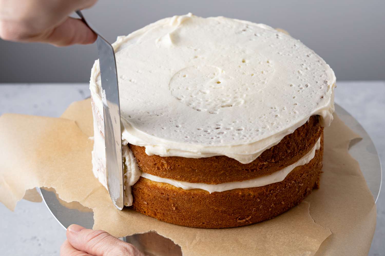 Crumb Coat of Lemon Lavender Cake Applied with Off-Set Spatula on a Cake Stand