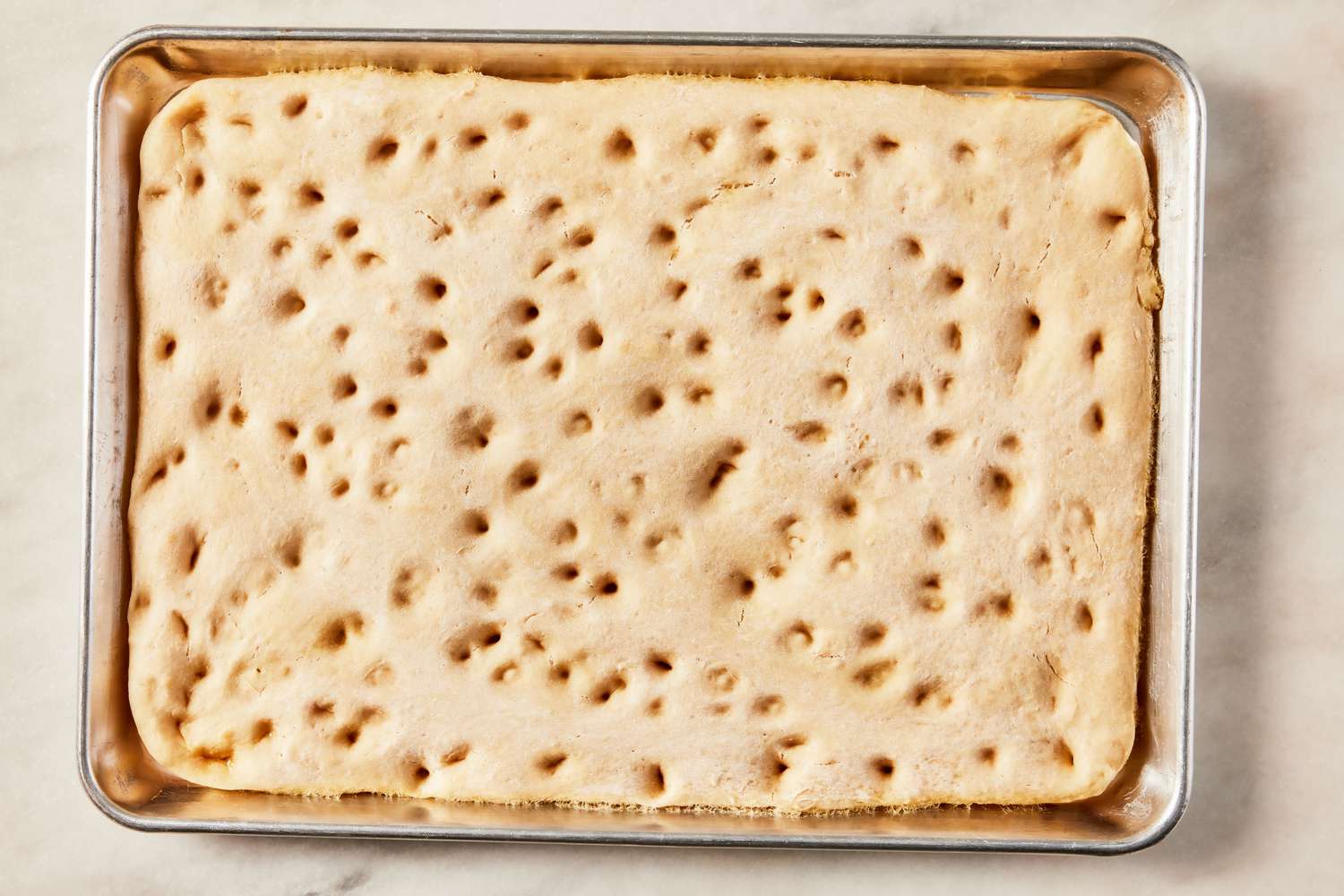 parbaked grandma pizza dough in a sheet pan