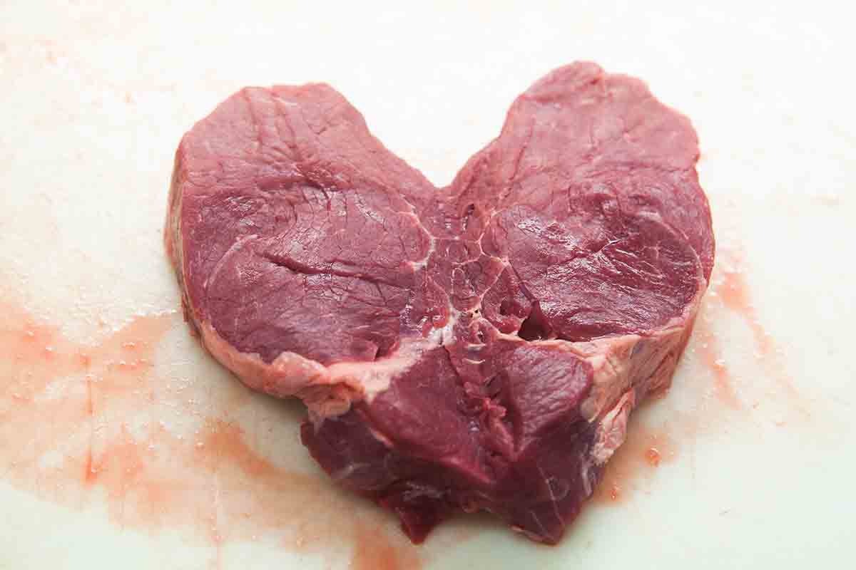 Filet mignon cut into a heart shape with the chain muscle still attached