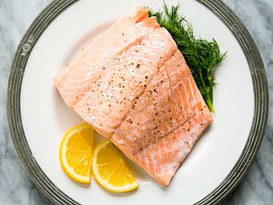 Poached Salmon with dill on a plate with silver trim