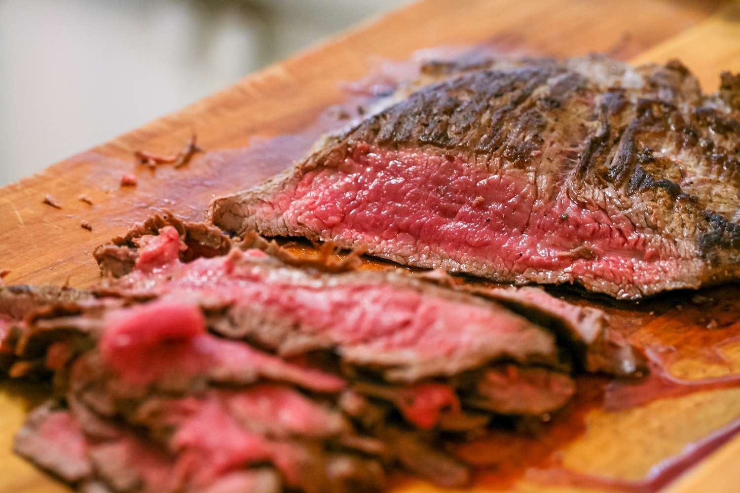 Flank steak slices on a cutting board.