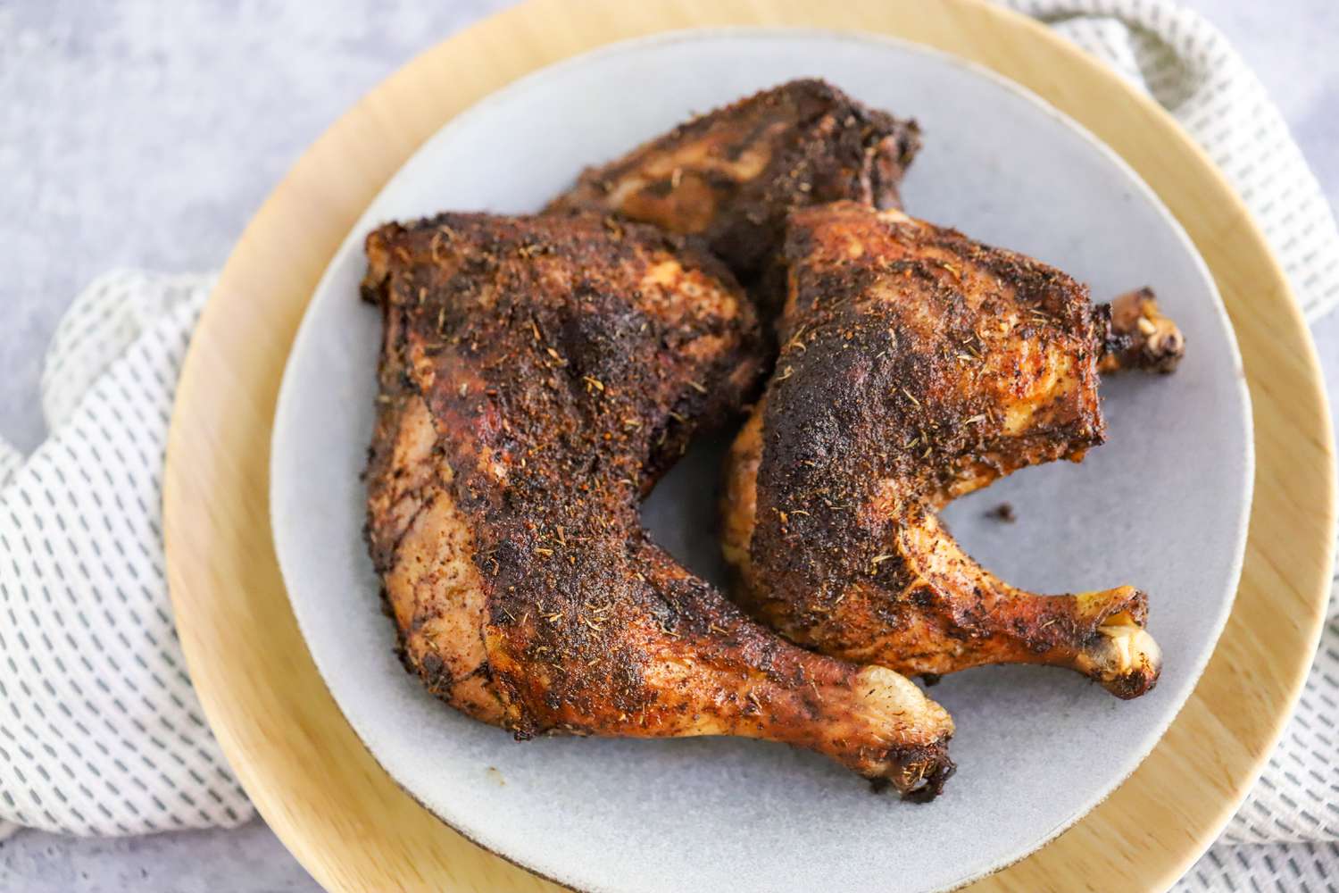 Plate of Jerk Chicken Thighs on a Kitchen Towel