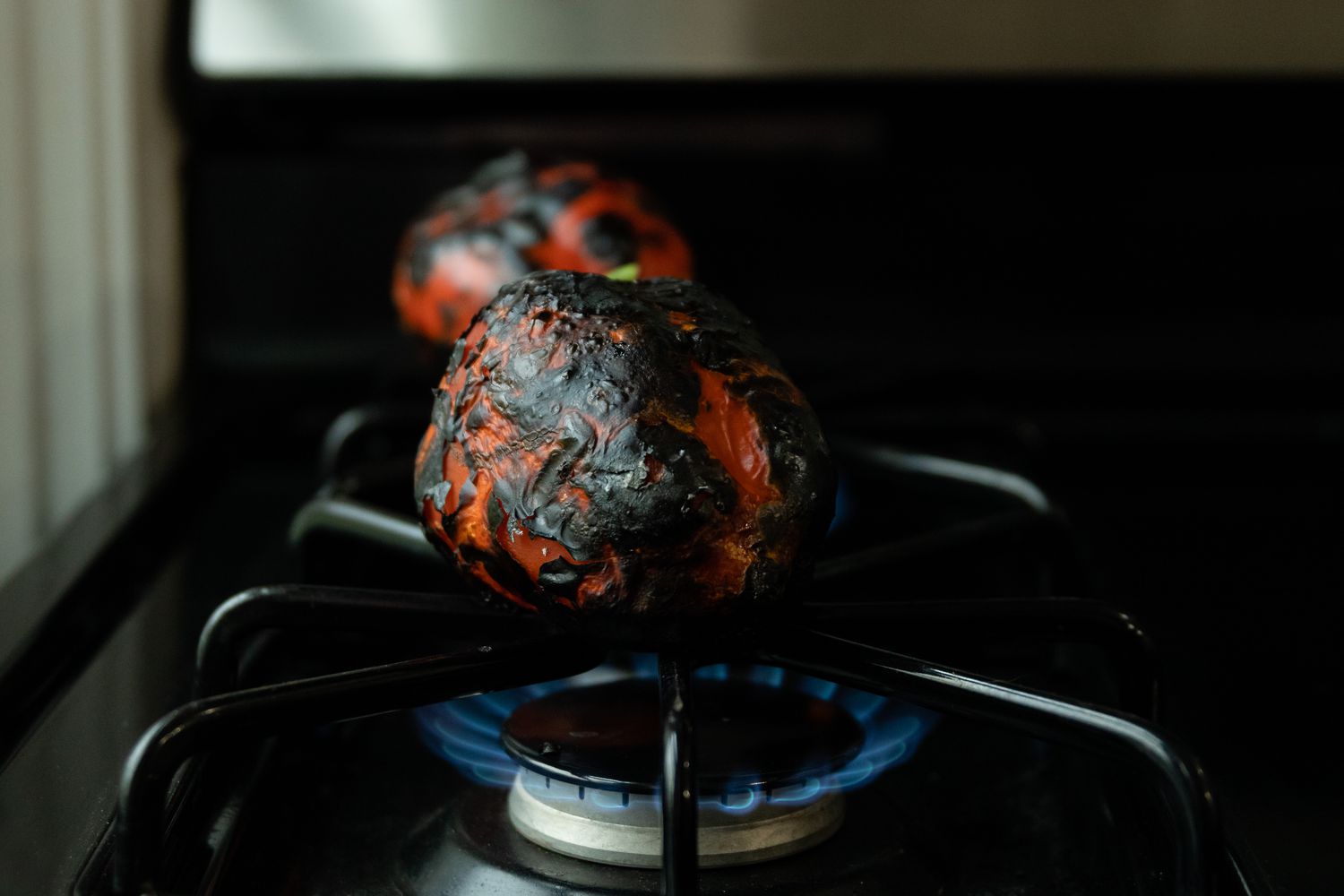 Roasting Peppers on Gas Stove for Smoked Spatchcock Chicken with Harissa Butter and Grilled Carrots