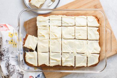 Banana Sheet Cake Frosted and Cut into Portions in a Glass Baking Dish