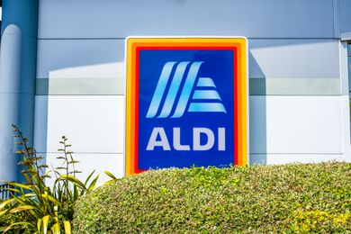 Aldi store sign outside blue background with the Aldi logo and text