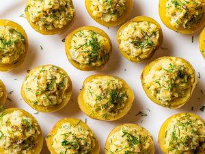 Halved potatoes with a creamy filling and garnished with herbs