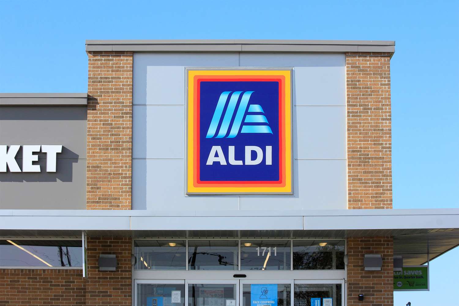 The front facade of an Aldi store with its sign prominently displayed and part of the entrance visible