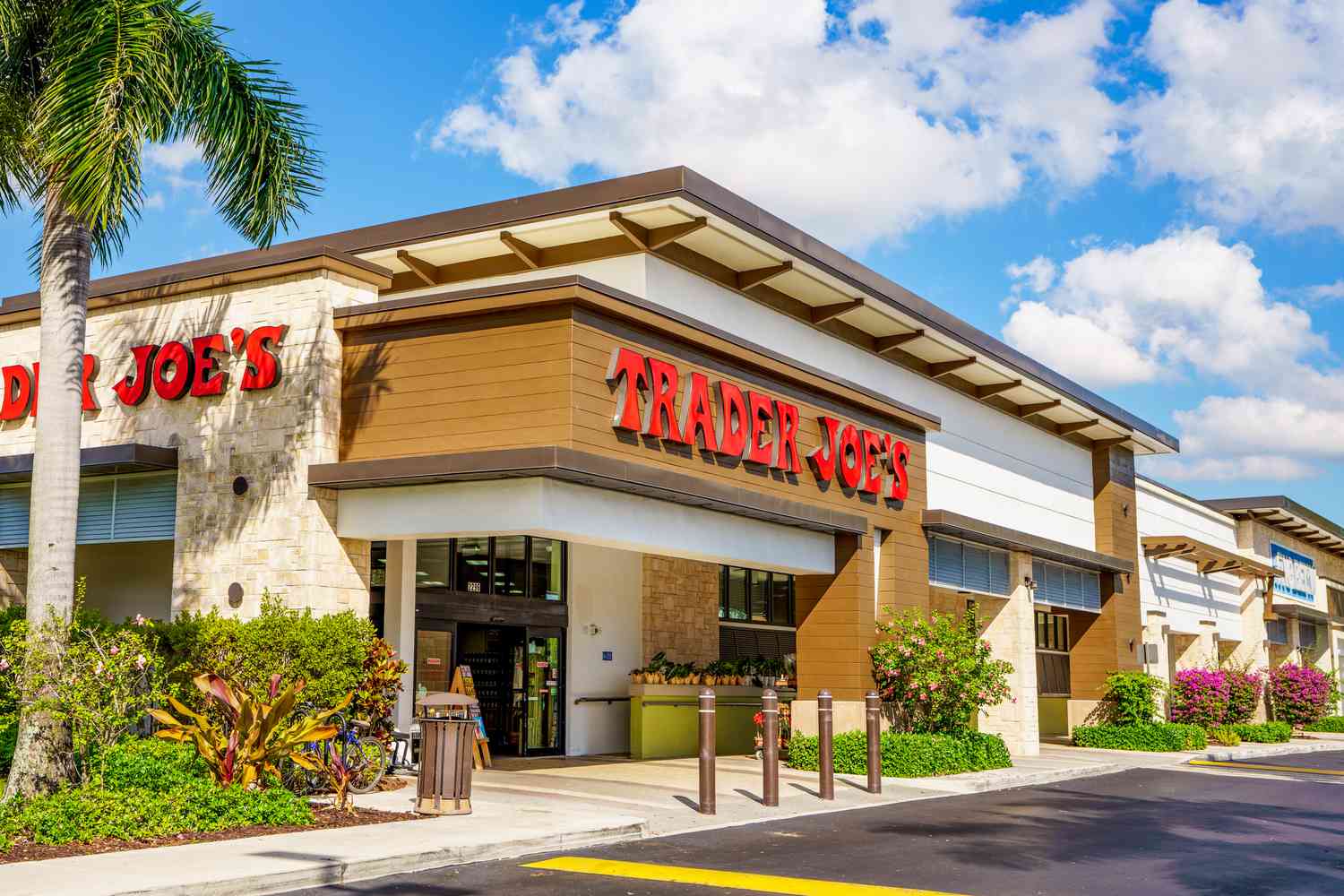 Trader Joe's storefront with clouds and blue sky overhead
