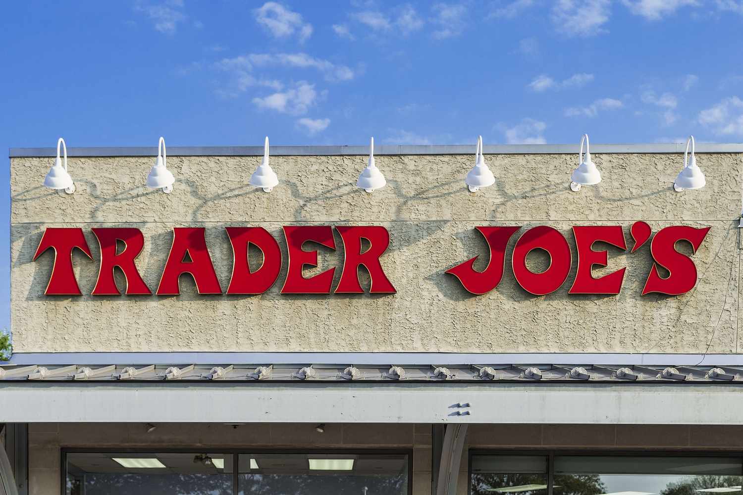 Trader Joes storefront sign wallmounted featuring the name in red letters