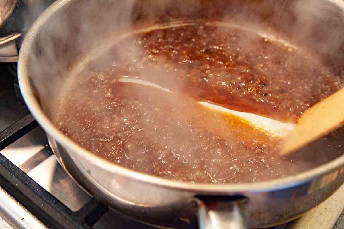 peppercorn sauce reducing in the pan