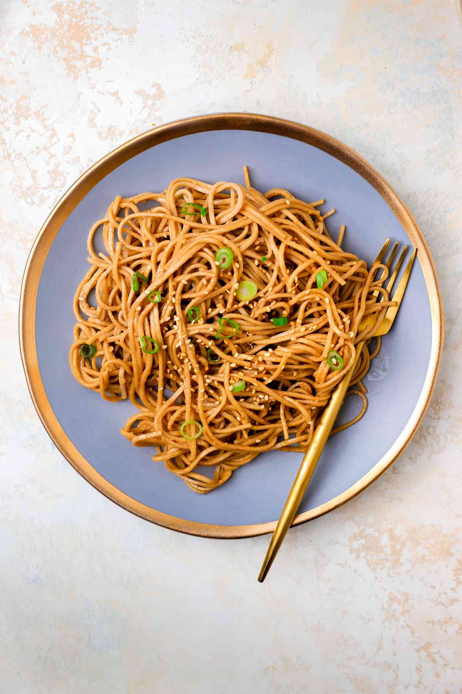 Quick and Easy Sesame Peanut Noodles on a Plate with a Fork