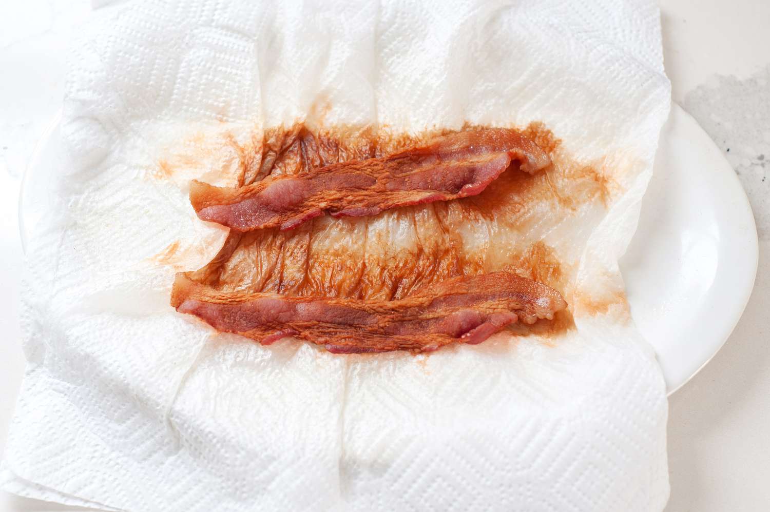 Cooked Microwave Bacon on a Paper Towel Lined Plate 