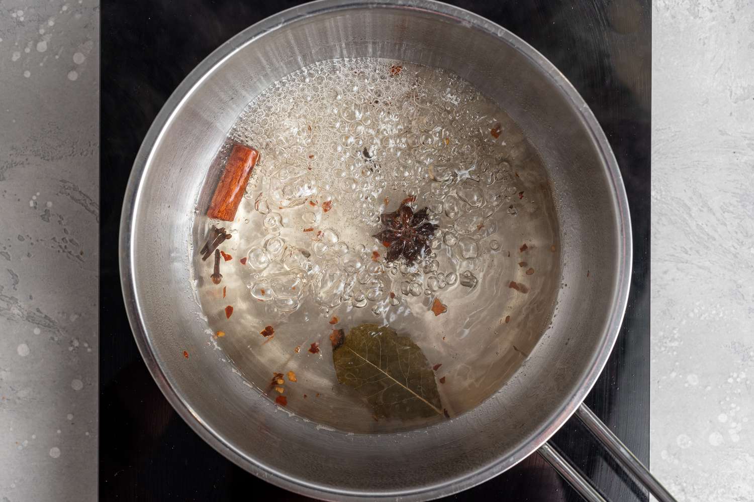  simmering spices and vinegar for pickled red onions recipe.