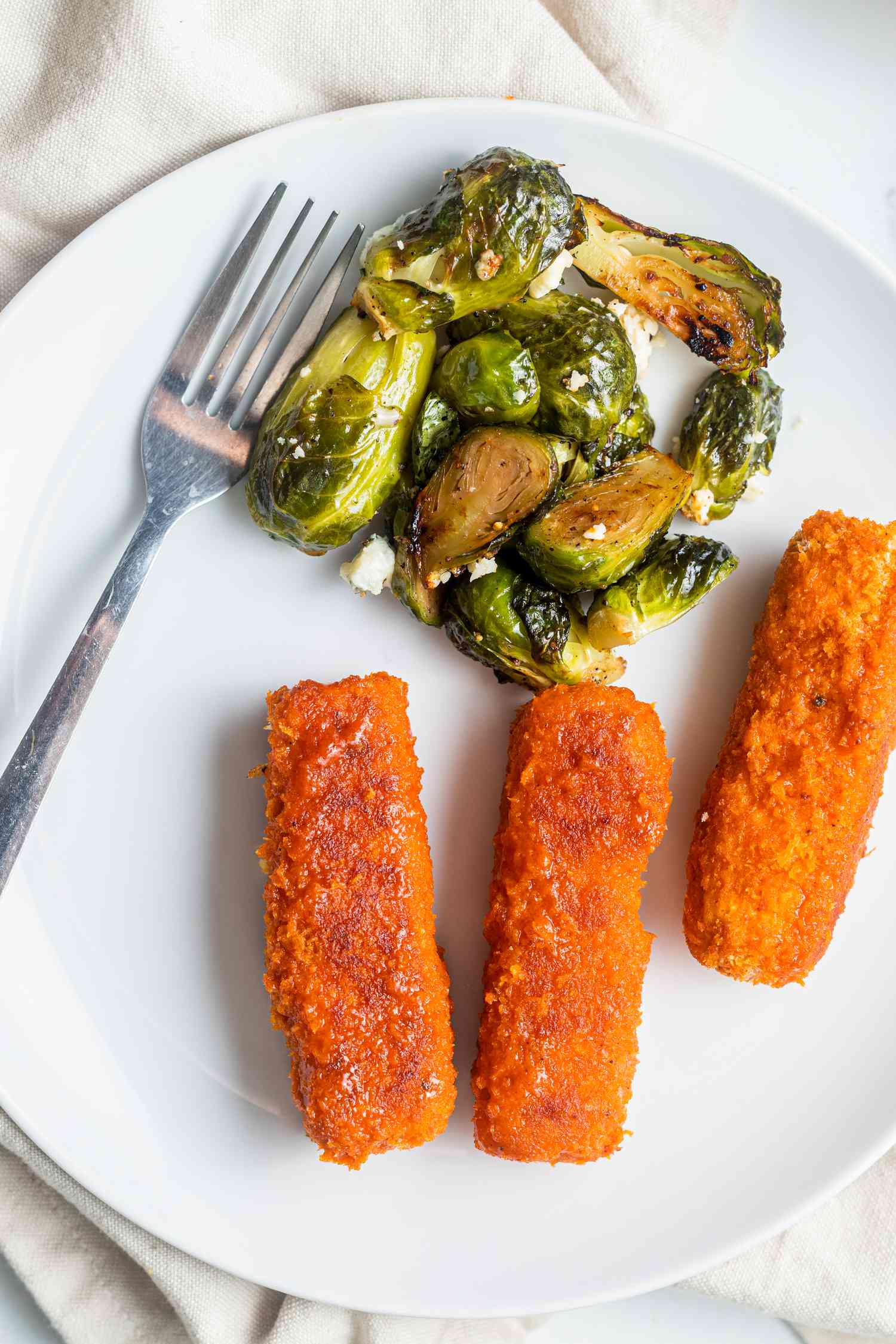 Sheet Pan Buffalo Tofu and Blue Cheese Brussels Sprouts on a Plate with a Fork
