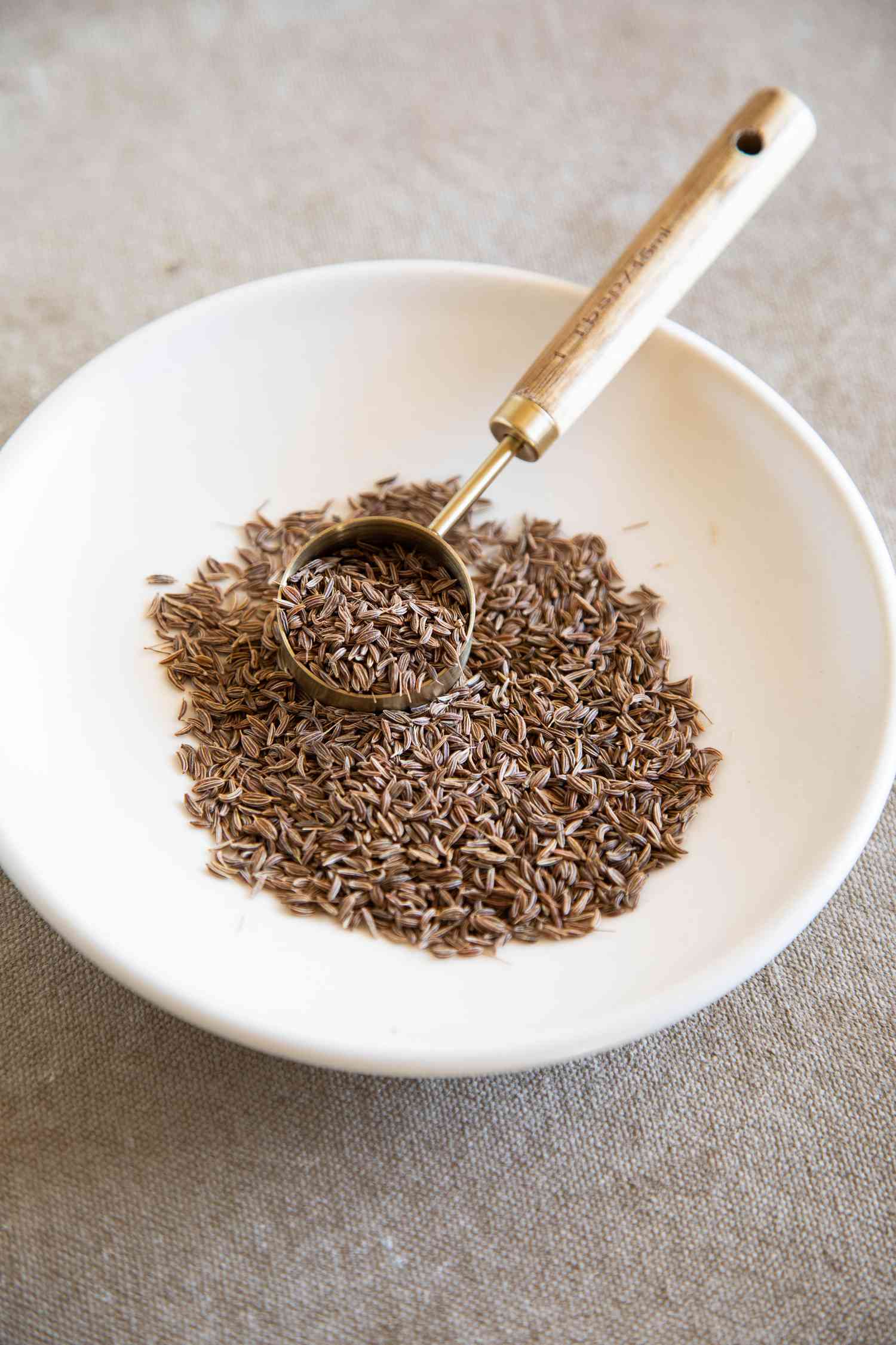 Caraway seeds in a white bowl