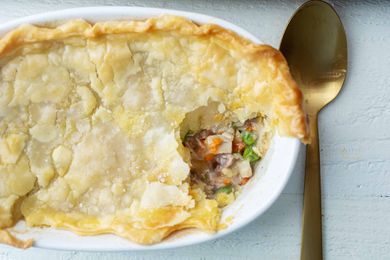 Leftover turkey pot pie in a large casserole dish with serving spoon