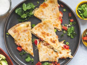 A plate of quesedillas and toppings.