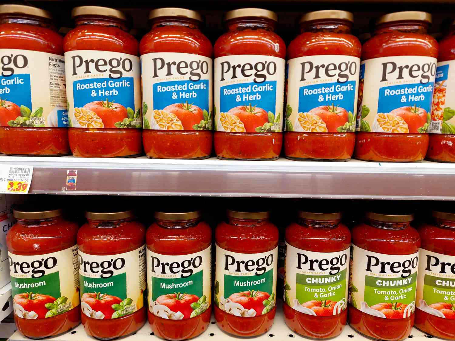 Shelves stocked with jars of Prego pasta sauce in various flavors