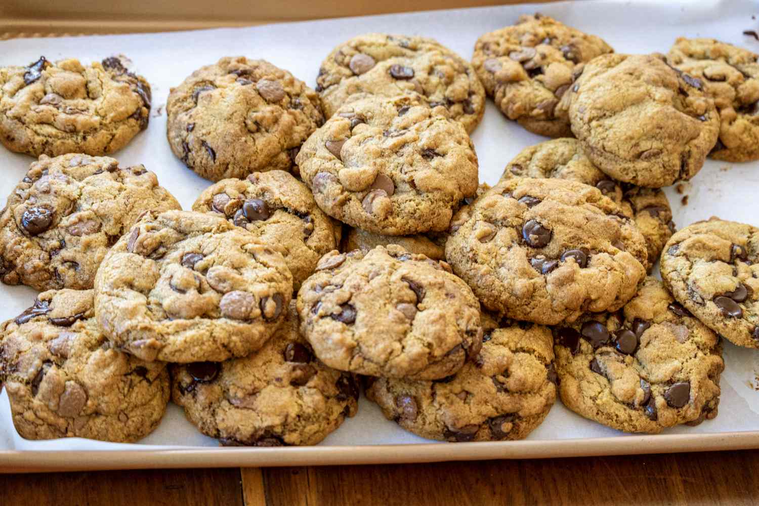 A tray of chocolate chip cookies arranged on a surface