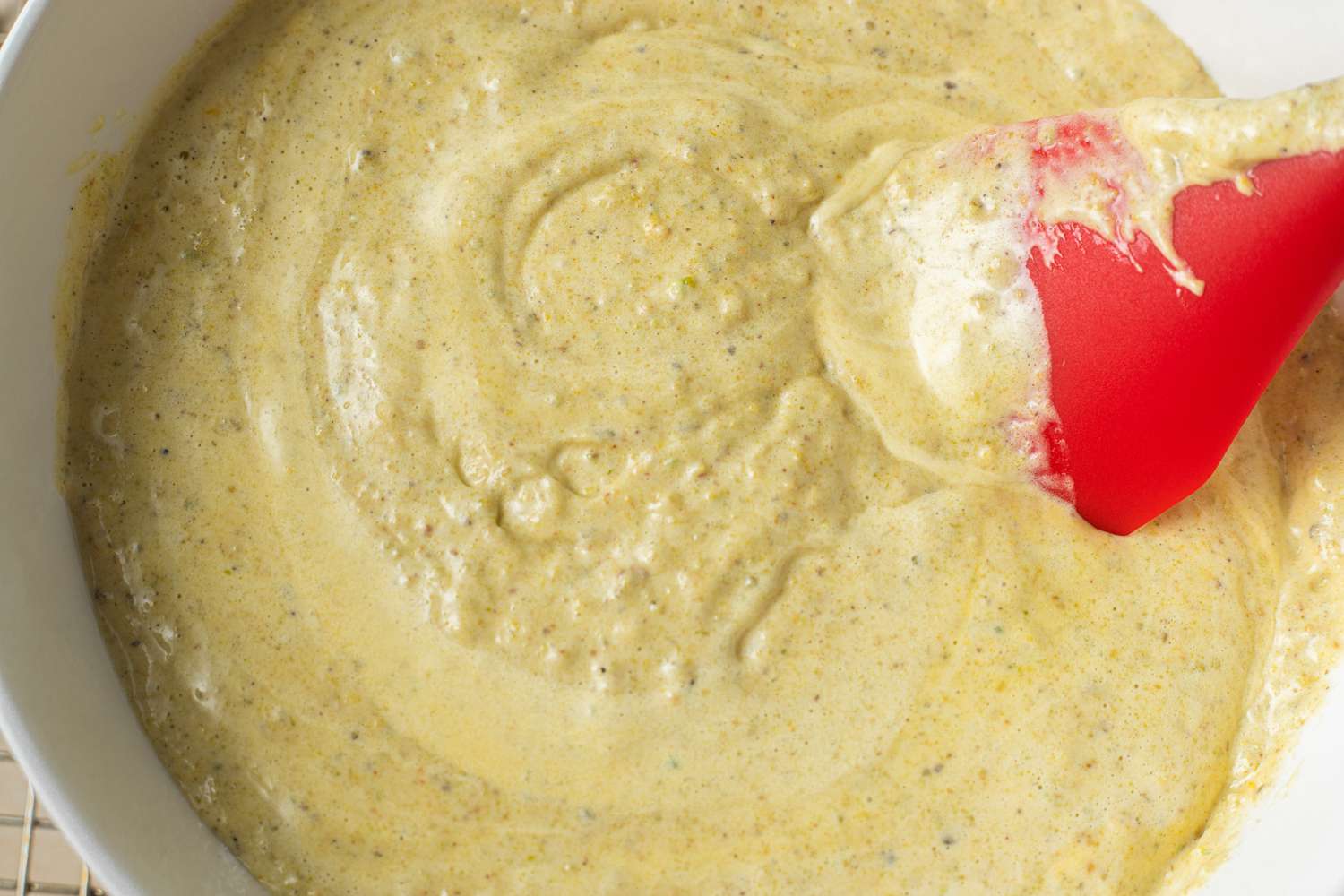 Bowl of Pistachio Cardamom Tres Leches Cake Batter