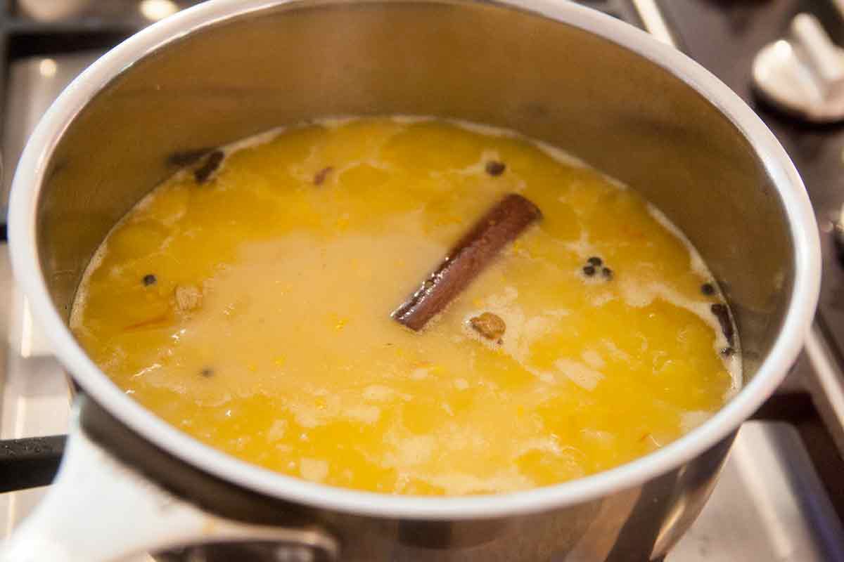 saffron rice being cooked in a salt, saffron, zesty water mixture 