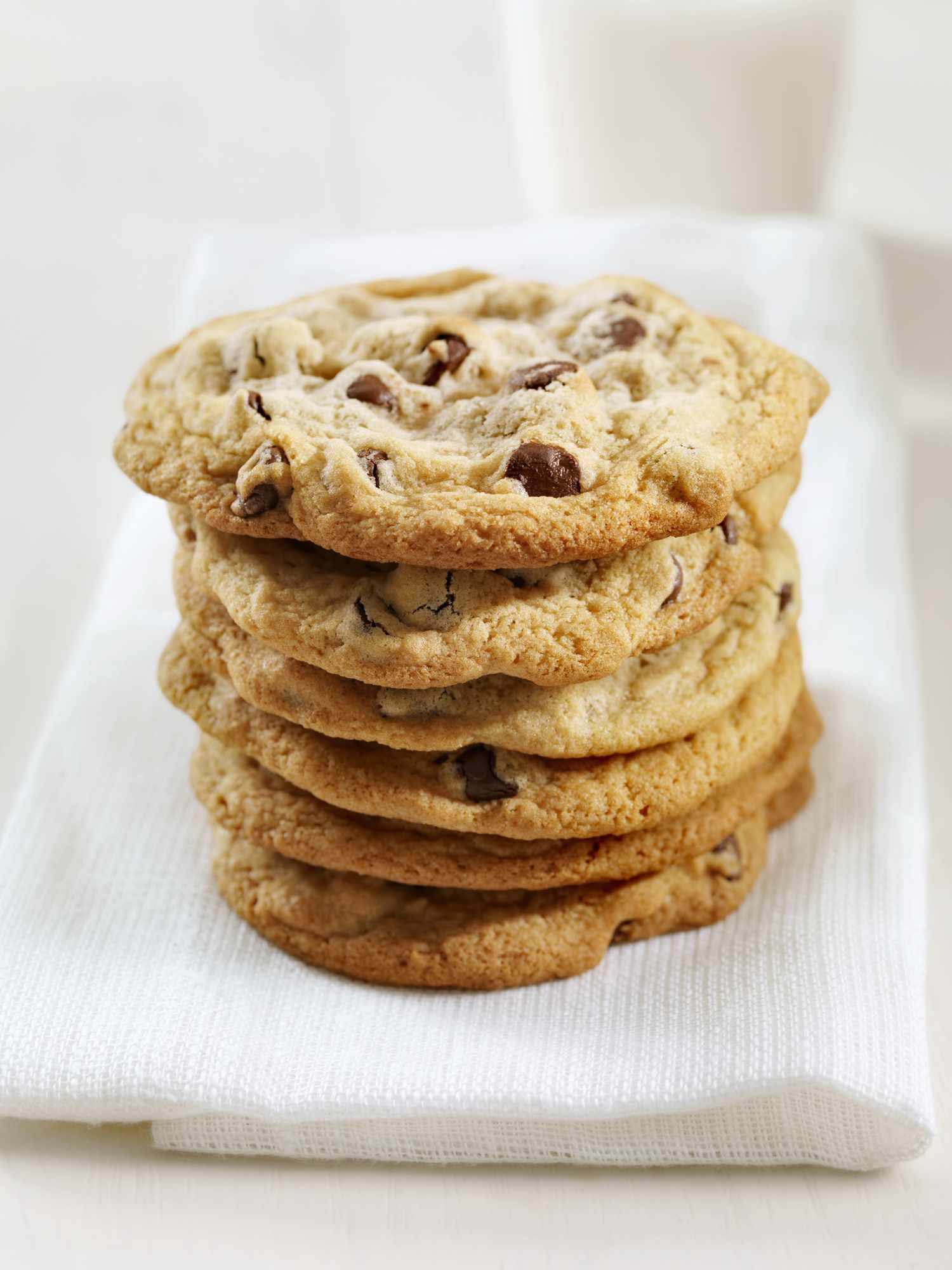 A stack of chocolate chip cookies on a napkin