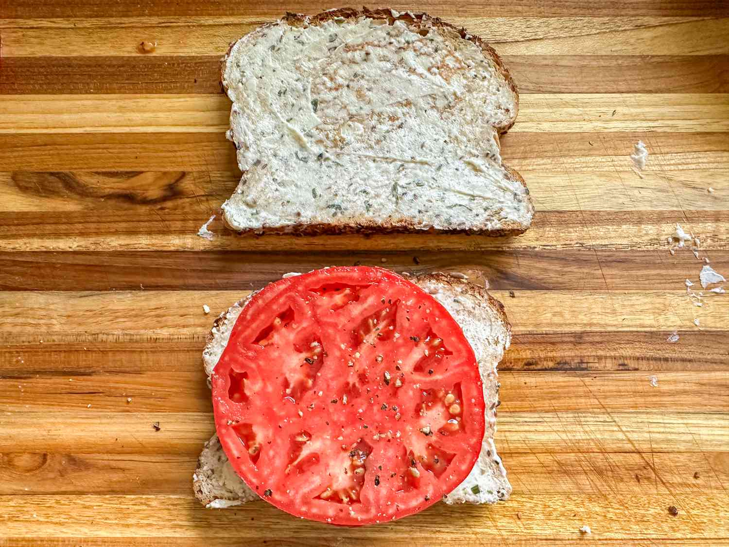 Slice of tomato on sliced bread with Boursin