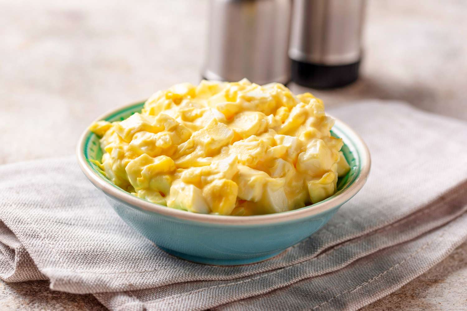 Side shot of egg salad in a bowl
