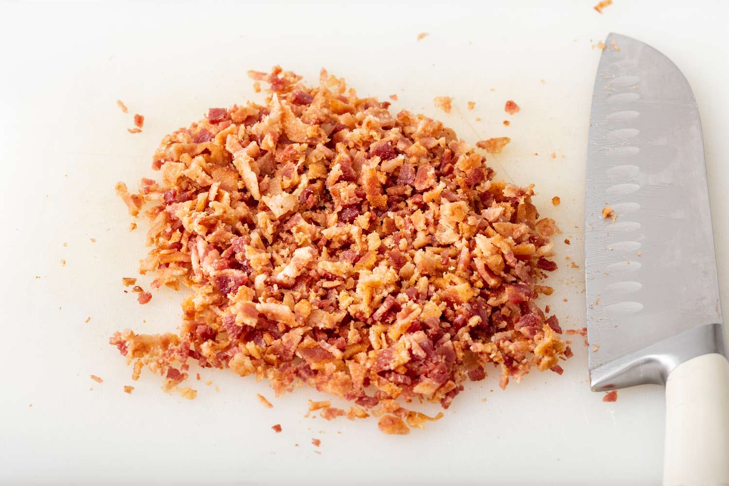 Chopped bacon on a cutting board to make the best potato salad recipe.