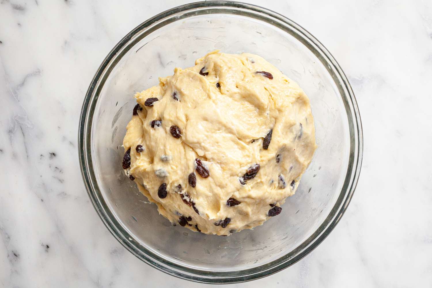 Cinnamon Swirl Raisin Brioche Loaf Dough Resting in a Glass Bowl 