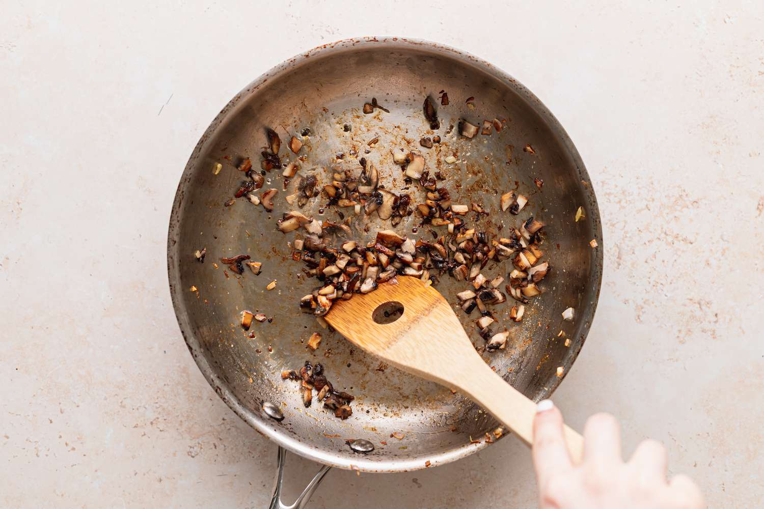 Sauteeing ingredients in a skillet to make vegan acorn squash.
