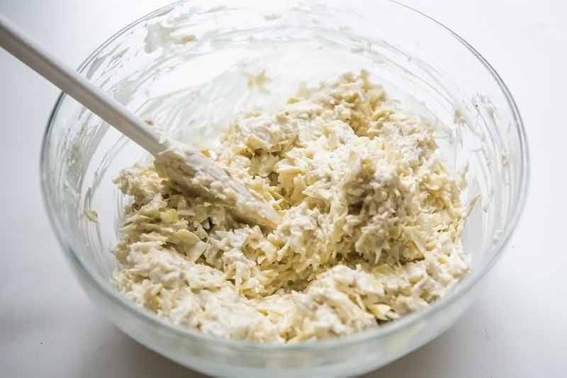 Pre Cooked Artichoke Dip Ingredients Stirred Together in Bowl 