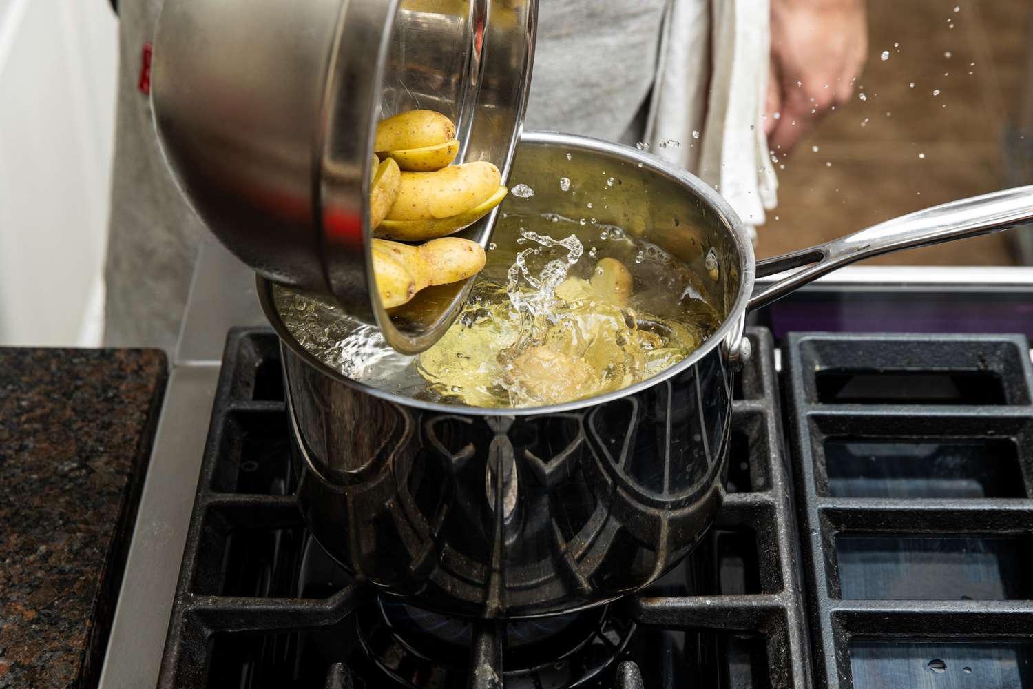 Halved Potatoes Added to a Pot of Water 
